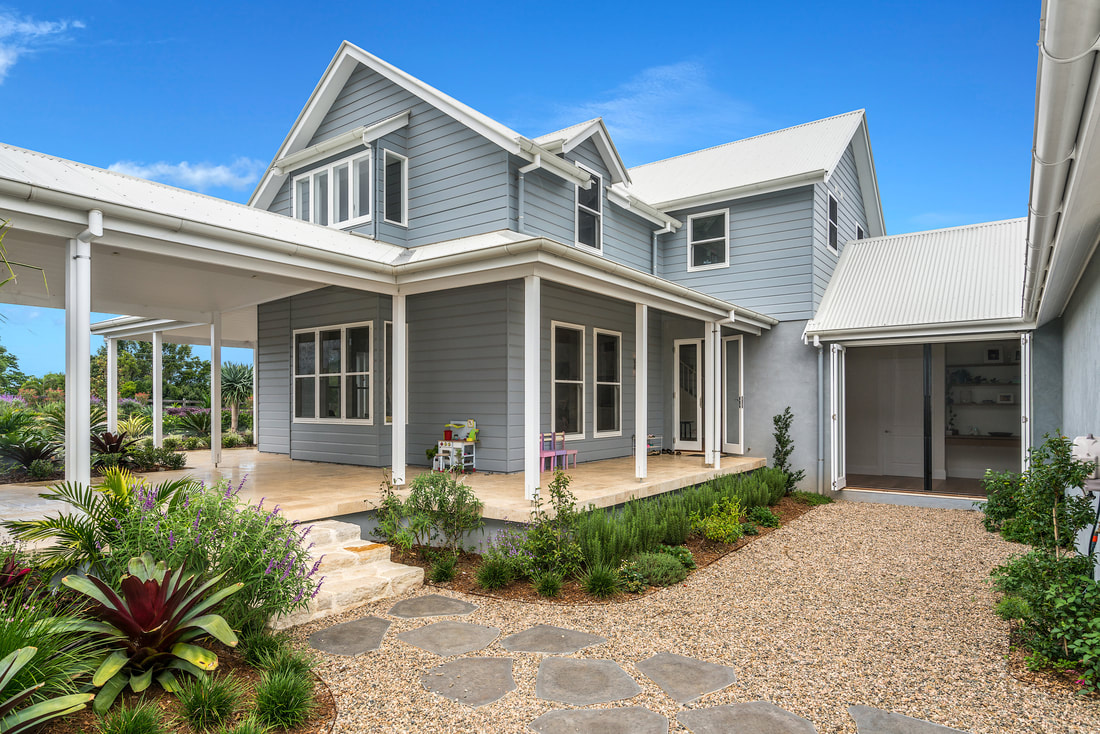 A weatherboard home with custom timber windows and a wide verandah